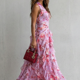 Pink floral halter maxi dress with ruched bodice and layered ruffle skirt, side view