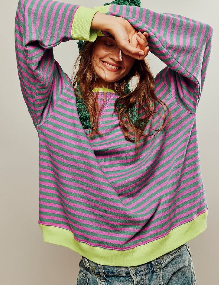 Oversized striped long-sleeve sweater in green and pink with light green cuffs and hem.