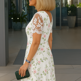 White floral midi dress with lace back sleeves, V-back detail, side view