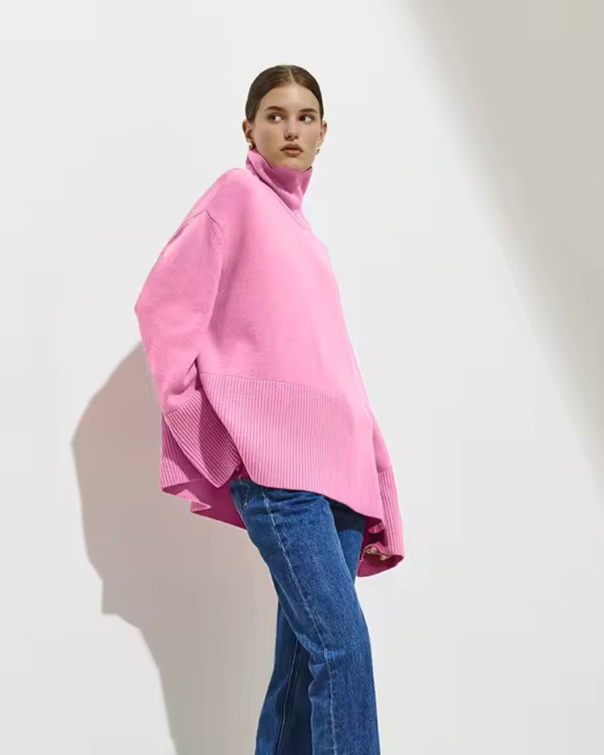 Pink oversized turtleneck sweater with long sleeves and ribbed cuffs