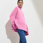 Pink oversized turtleneck sweater with long sleeves and ribbed cuffs