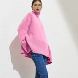 Pink oversized turtleneck sweater with long sleeves and ribbed cuffs