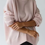 Oversized light pink turtleneck knit sweater with ribbed hem and cuffs