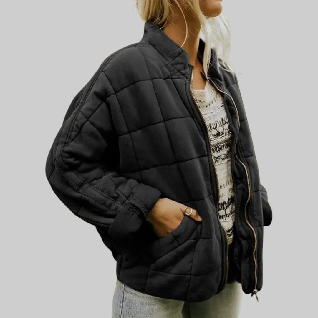 Black quilted oversize step jacket with zip front, stand collar, and side pockets