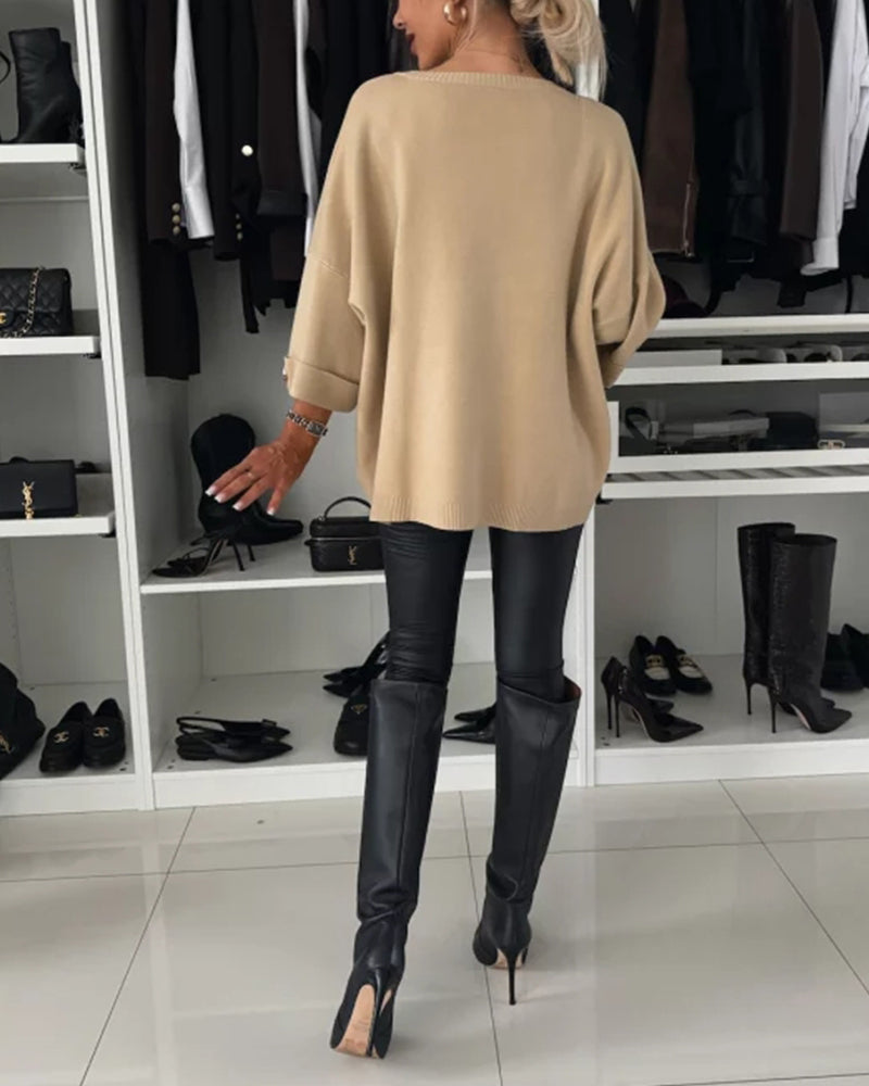 Beige knit pullover back view, loose fit with wide sleeves and ribbed hem