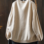Light cream knit cardigan, crew neckline, ribbed hem and long balloon sleeves.