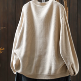 Light cream knit cardigan, crew neckline, ribbed hem and long balloon sleeves.