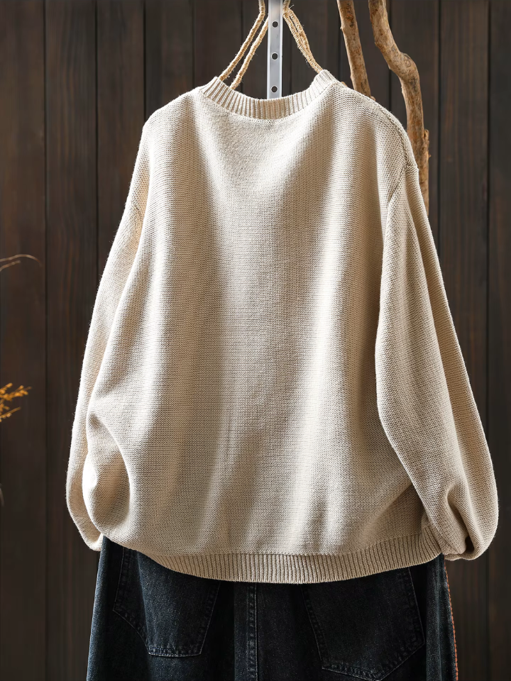 Light cream knit cardigan, crew neckline, ribbed hem and long balloon sleeves.