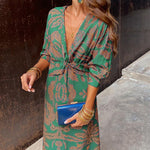 Green patterned wrap-style midi dress with knotted waist and long sleeves