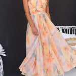 Peach watercolor halter maxi dress with sleeveless high neckline and full skirt