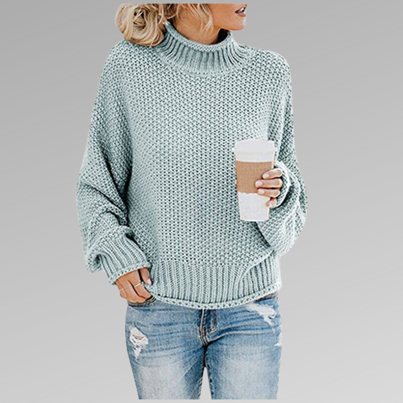Light teal chunky knit sweater with ribbed turtleneck, long sleeves, and straight hem