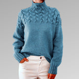 Women's cable-knit turtleneck sweater, light blue with raised cable pattern.