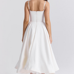 White corset-style dress back view with spaghetti straps and flared midi skirt