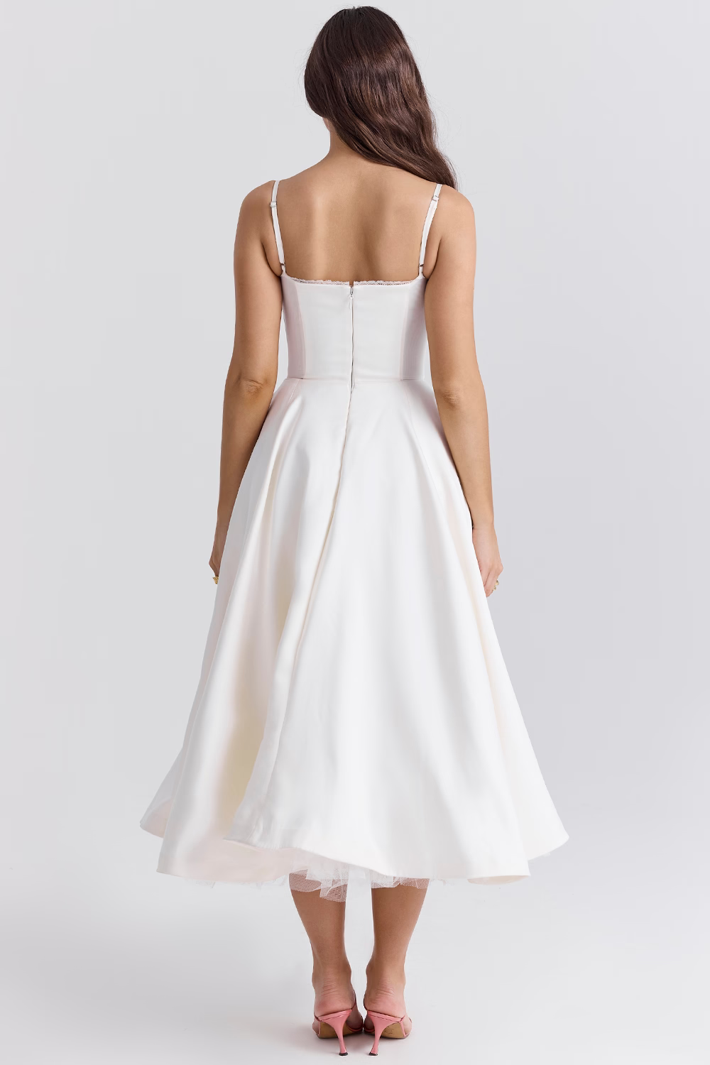 White corset-style dress back view with spaghetti straps and flared midi skirt