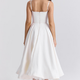 White corset-style dress back view with spaghetti straps and flared midi skirt