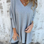 Light blue V-neck pullover sweater with wide sleeves and relaxed hem.