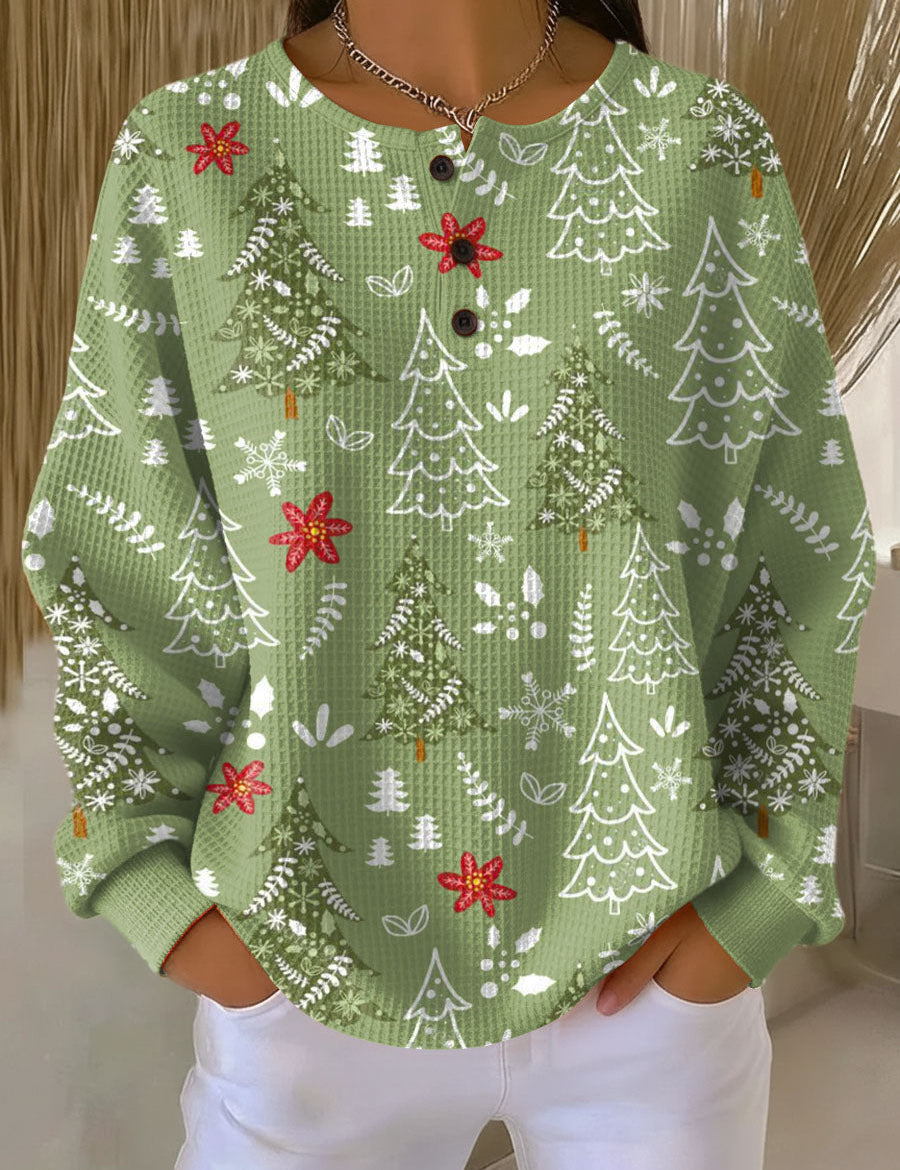 Green crewneck pullover with Christmas tree print, snowflakes, and red bows