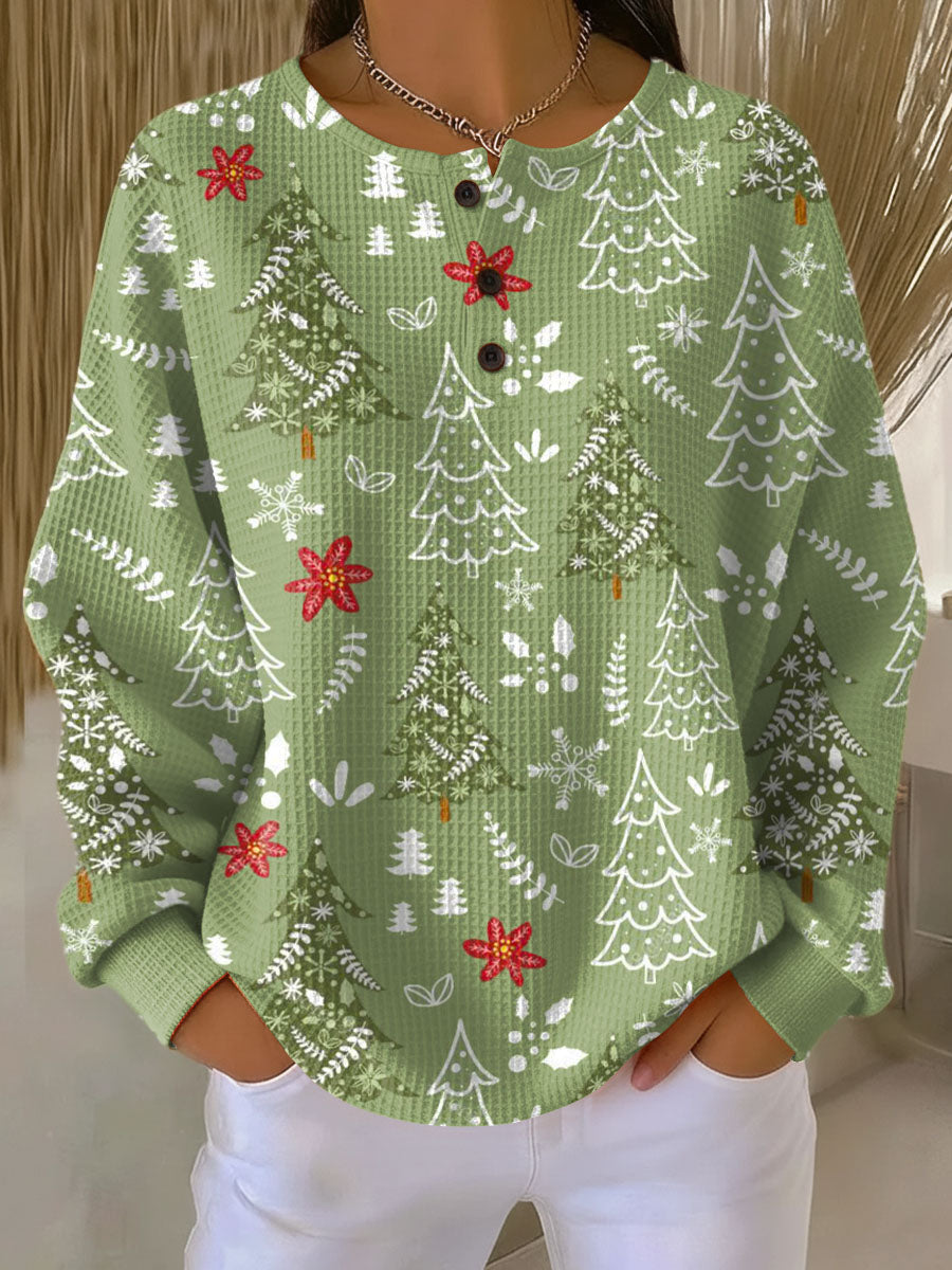 Green crewneck pullover with Christmas tree print, snowflakes, and red bows