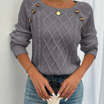 Gray cable-knit crewneck sweater with decorative shoulder buttons and ribbed cuffs