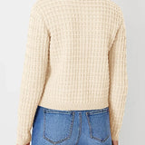 Cream knit cardigan back view with textured stitch pattern and ribbed waistband