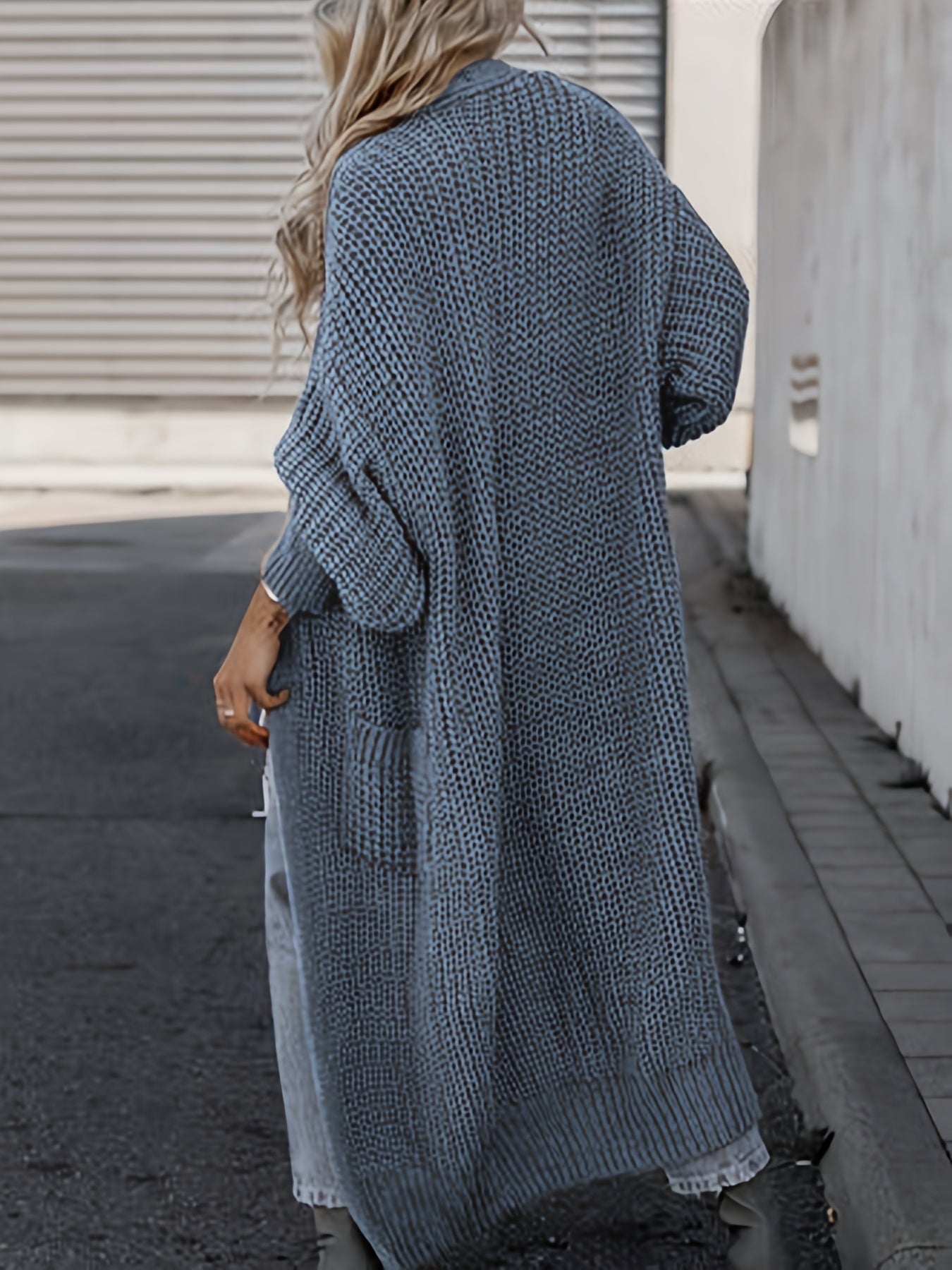 Blue long knit cardigan with open front, long sleeves, and side pockets