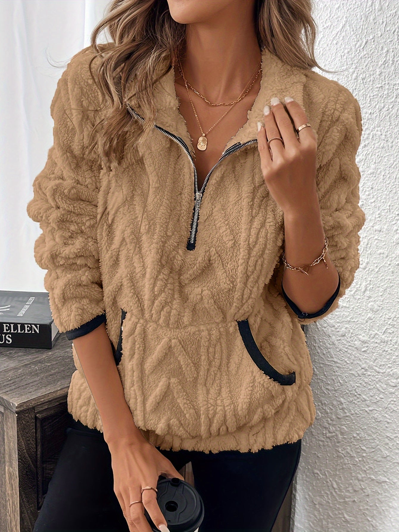Beige fuzzy quarter-zip pullover with short sleeves and navy-trim accents
