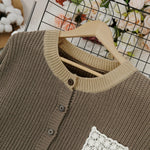 Close-up dark brown knit cardigan with button placket and crocheted square chest patch