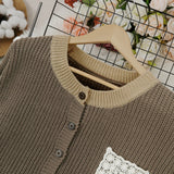 Close-up dark brown knit cardigan with button placket and crocheted square chest patch