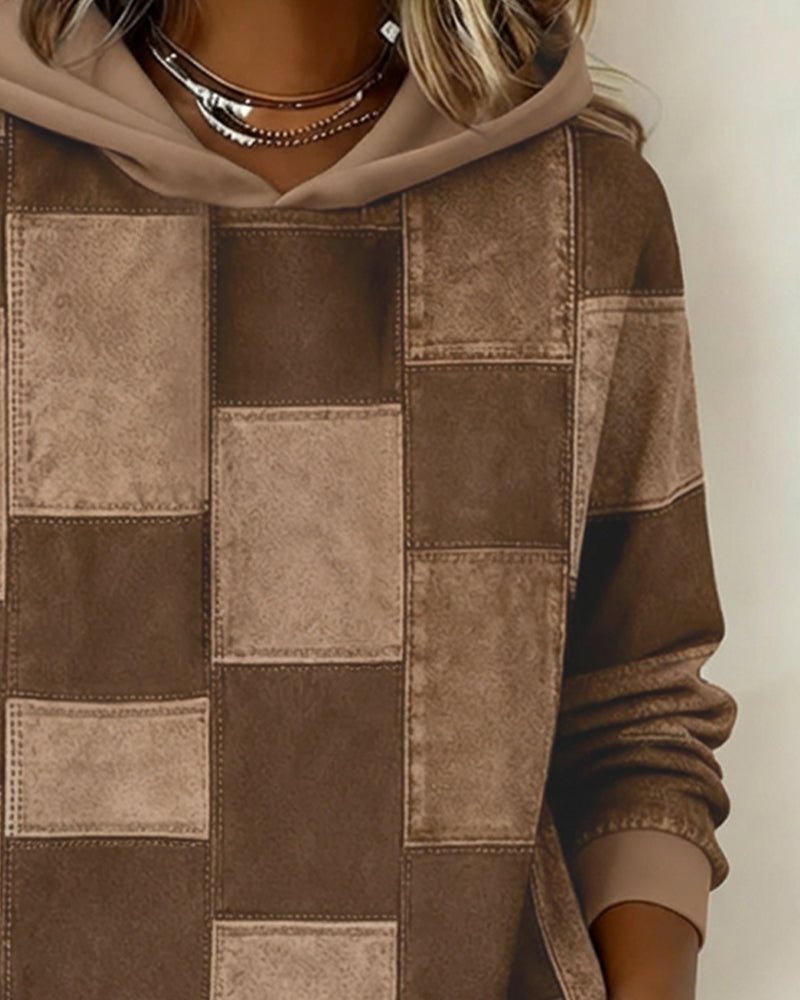 Brown patchwork hoodie close-up with hood and drawstring, stitched square panels