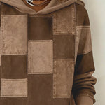 Brown patchwork hoodie close-up with hood and drawstring, stitched square panels
