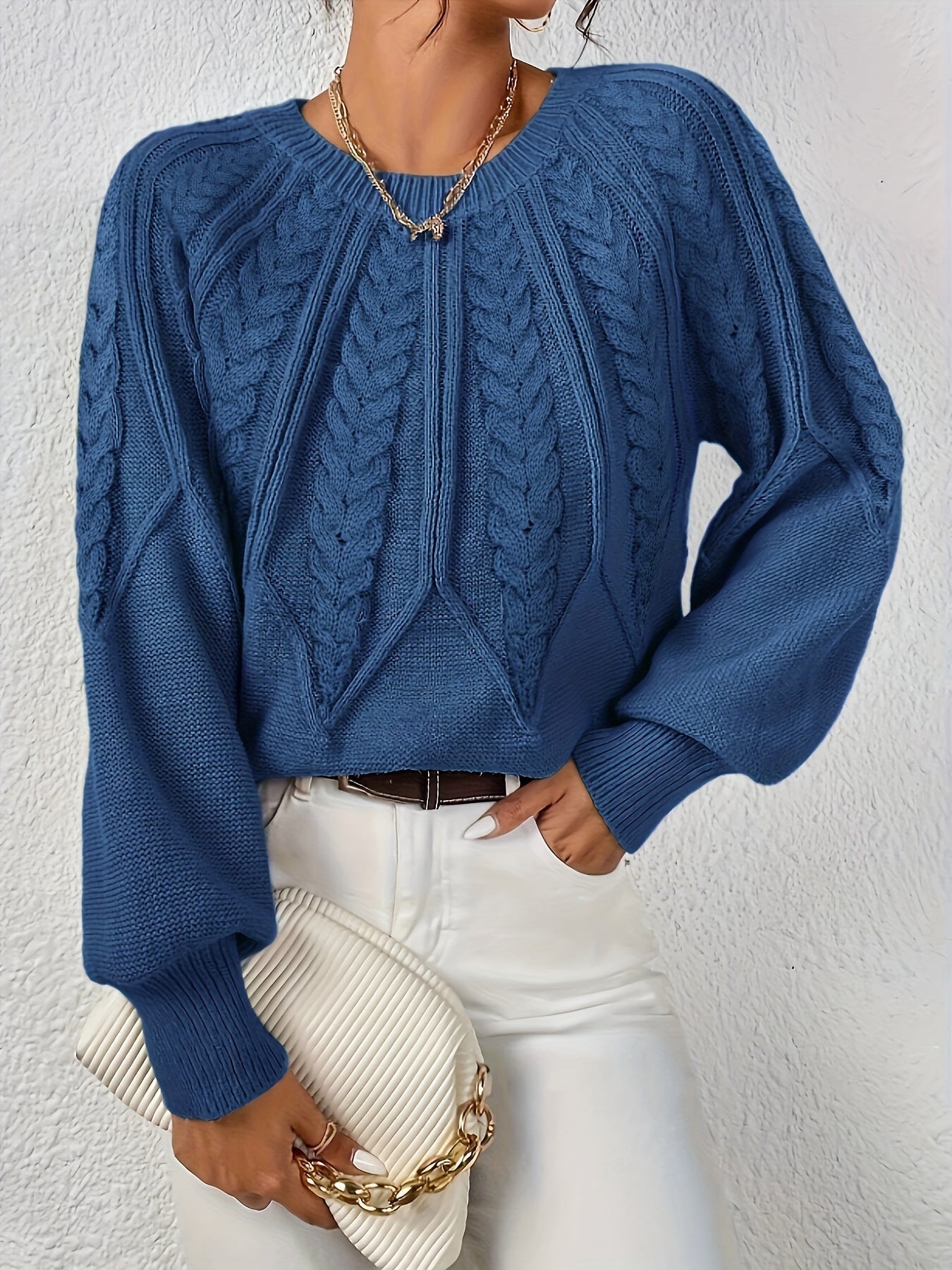 Blue cable-knit long-sleeve pullover with half-zip neckline and ribbed cuffs