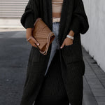 Black long knit cardigan with open front, long sleeves, and side pockets