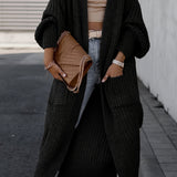 Black long knit cardigan with open front, long sleeves, and side pockets