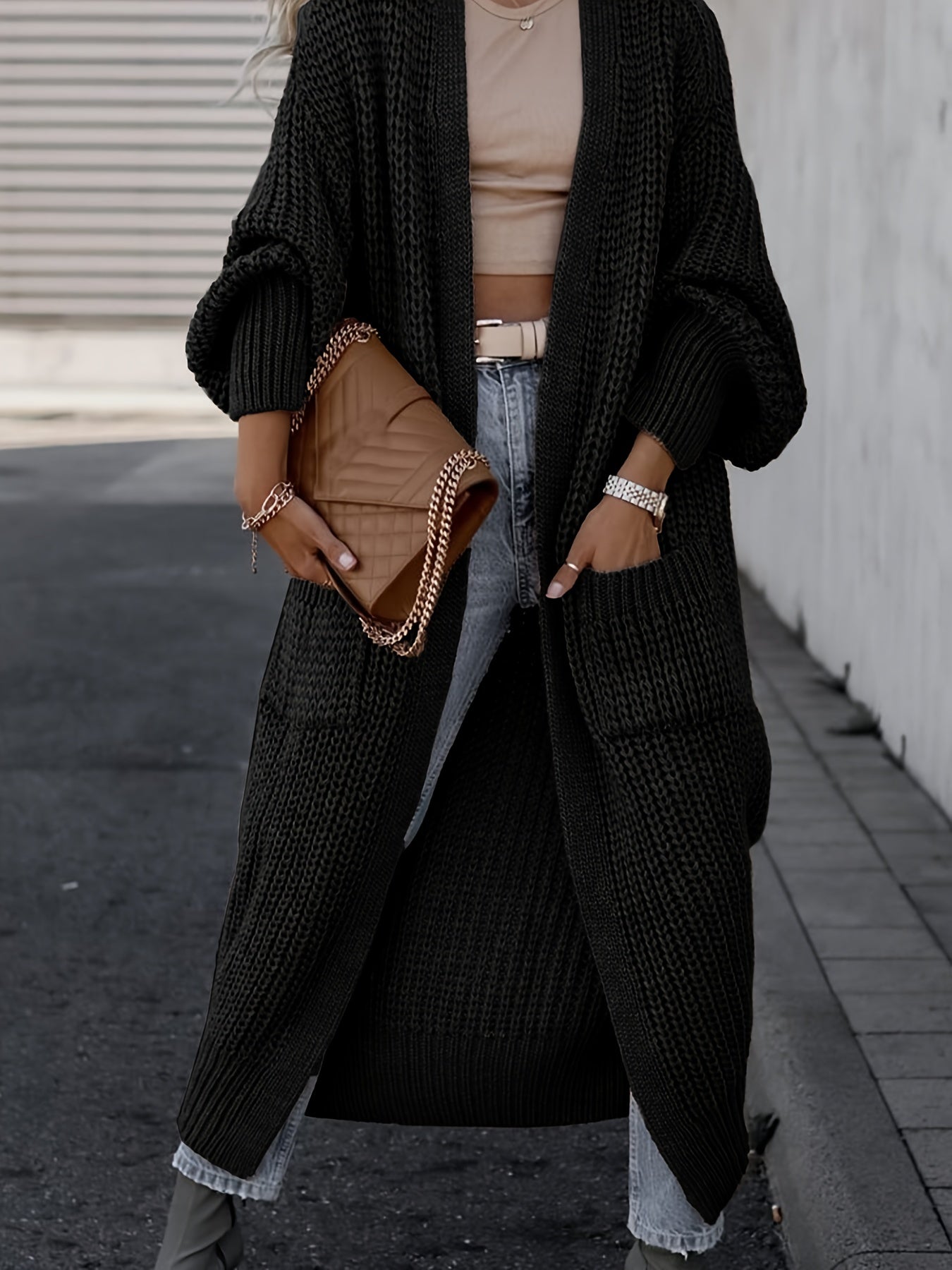 Black long knit cardigan with open front, long sleeves, and side pockets