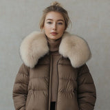 Brown puffer jacket with cream faux fur collar and front zipper, worn by model