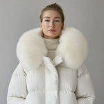 White puffer jacket with white faux fur collar and front zipper, worn by model