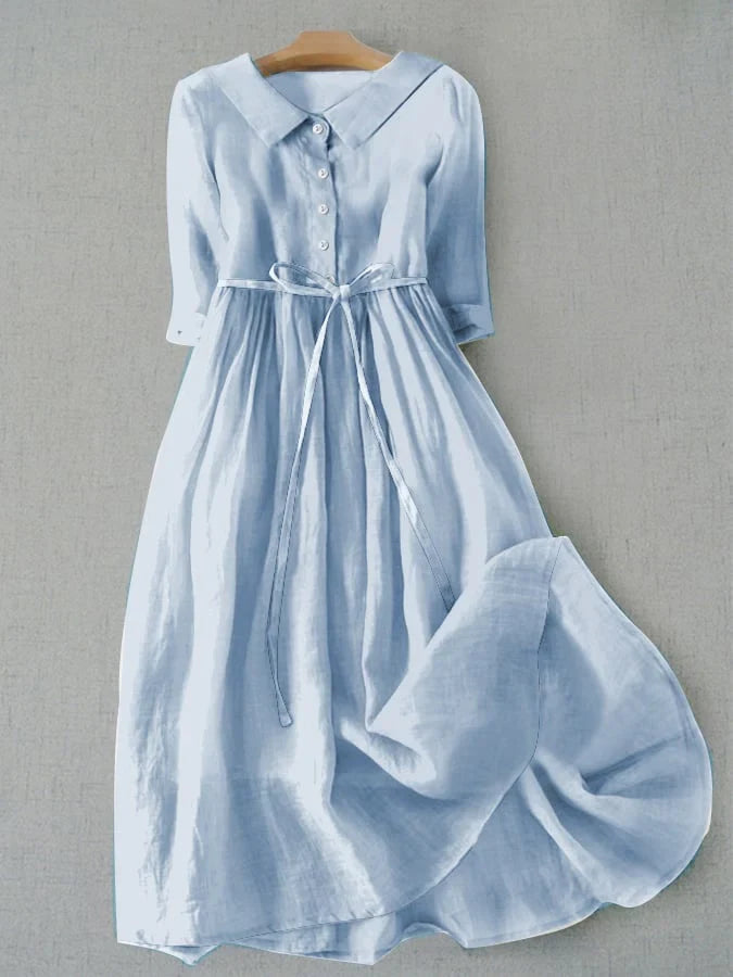 Light blue button-front tie-waist dress with 3/4 sleeves and gathered skirt.