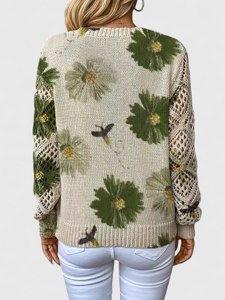 Back view of relaxed floral pullover, cream knit with green flower pattern, long sleeves
