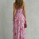 Pink floral halter maxi dress with open back, ruched seams, and tiered ruffle skirt