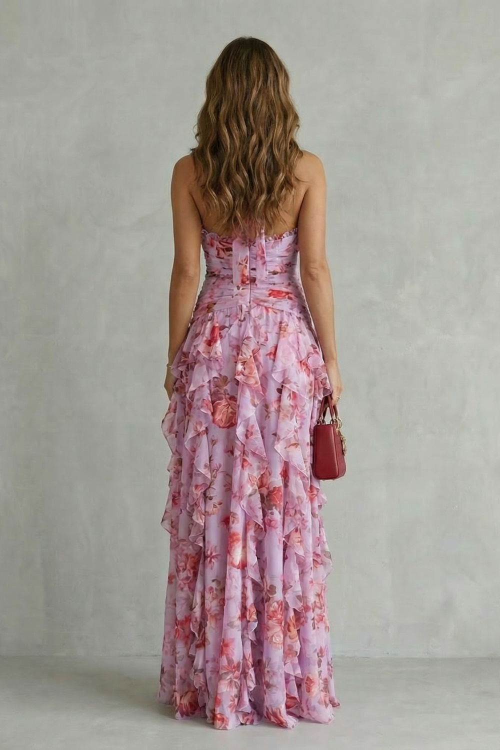 Pink floral halter maxi dress with open back, ruched seams, and tiered ruffle skirt