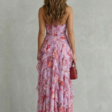 Pink floral halter maxi dress with open back, ruched seams, and tiered ruffle skirt
