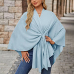 Light blue draped poncho with V-neck and gathered front knot, wide cape sleeves
