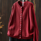 Red knit cardigan with round neckline, button-front placket and long sleeves.