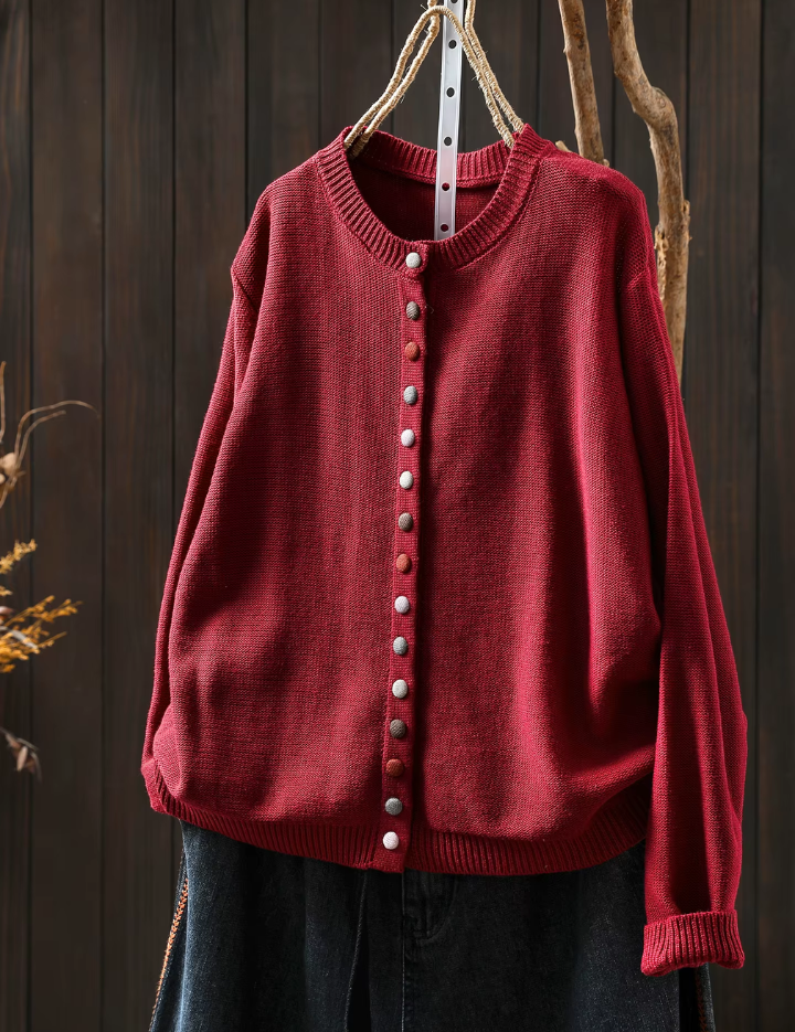 Red knit cardigan with round neckline, button-front placket and long sleeves.