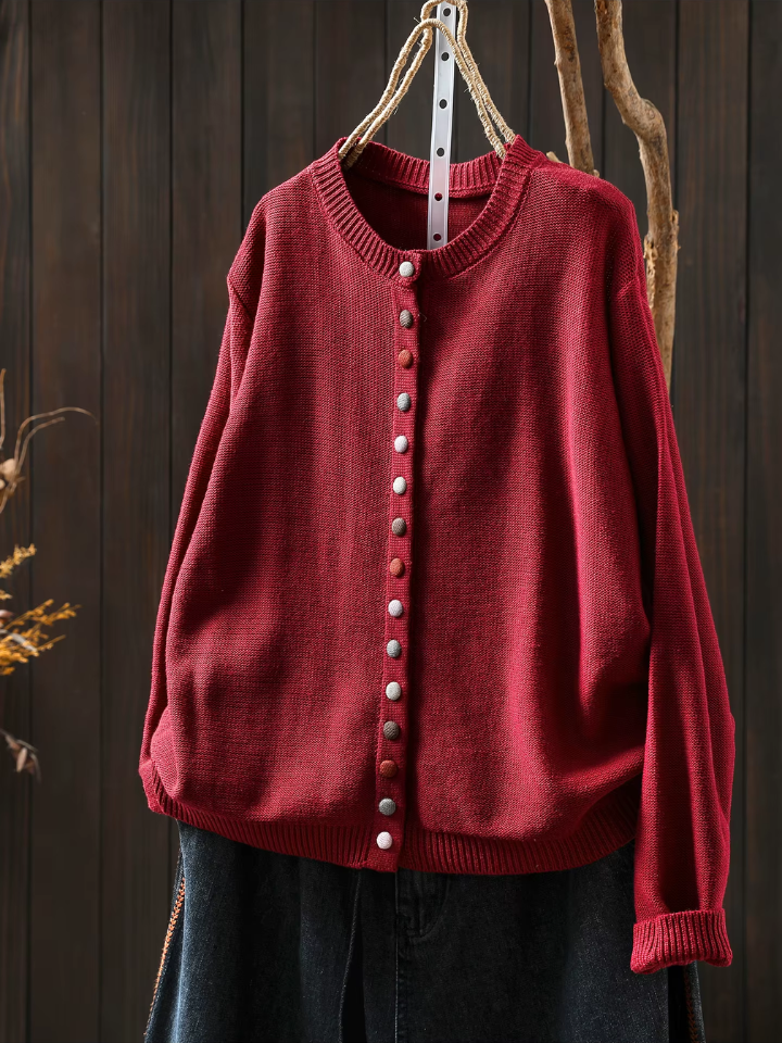 Red knit cardigan with round neckline, button-front placket and long sleeves.