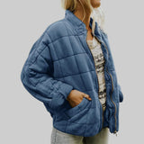 Blue quilted oversize step jacket with zip front, stand collar, and side pockets