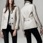 White quilted fall jacket with button front, stand collar, and belt tie