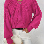 Fuchsia cable-knit long-sleeve pullover with half-zip neckline and ribbed cuffs