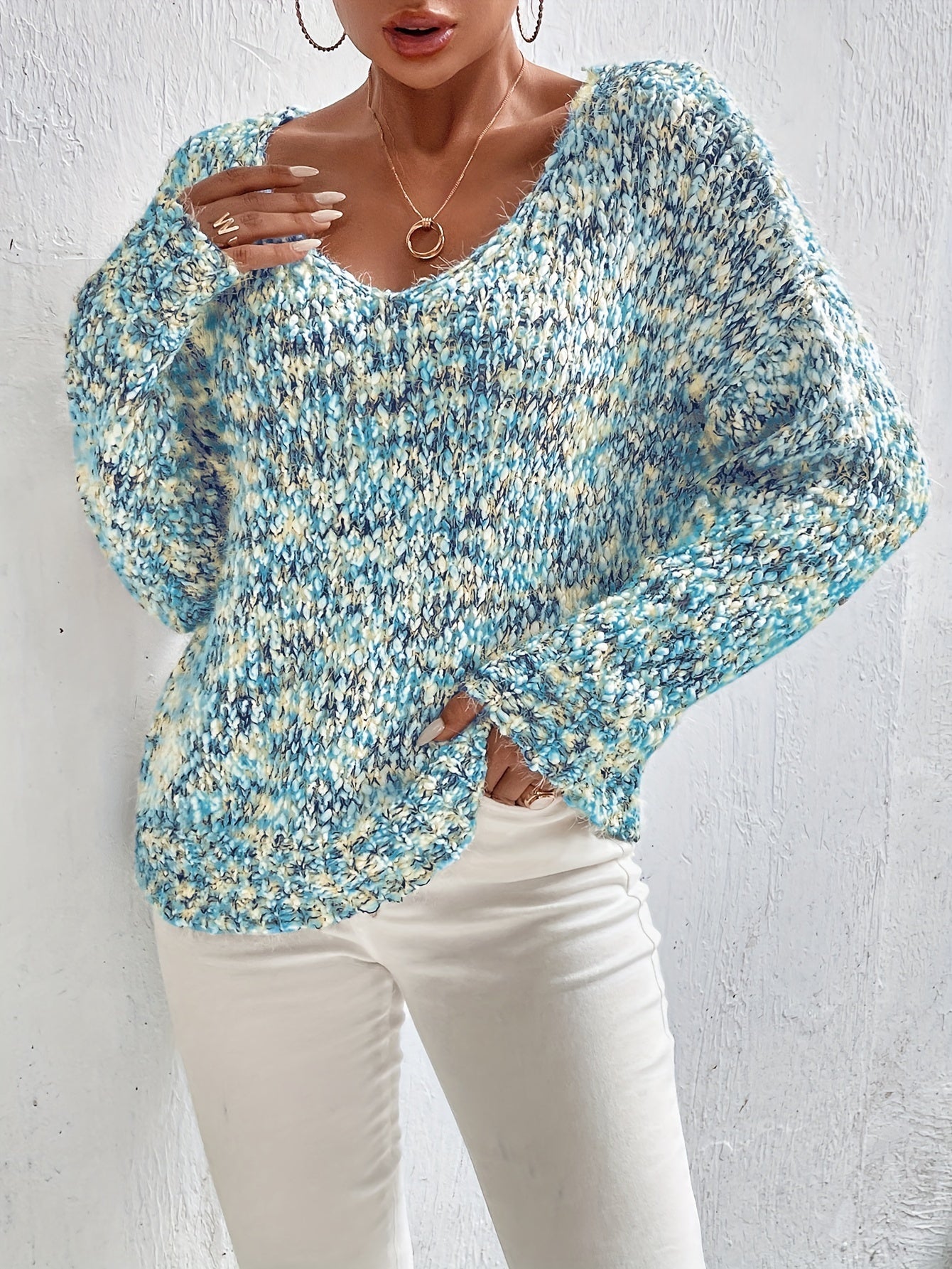 Loose knit pullover sweater with long sleeves, blue-and-white speckled texture