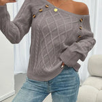 Gray cable-knit long-sleeve sweater with wide neckline and gold button accents